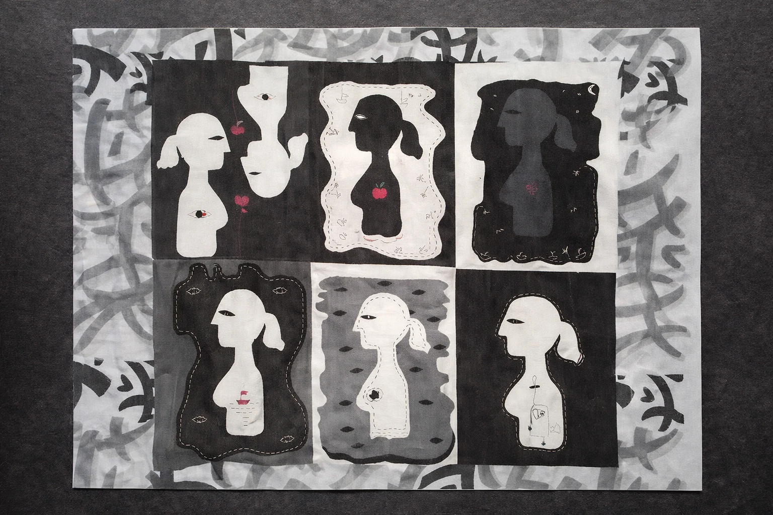 Six silhouettes across black, white and grey textile panels